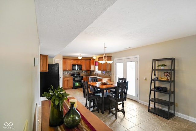 101 Meadowview Dr, Mooresville, IN 46158 - dining space with light tile patterned floors, baseboards, a textured ceiling, and a chandelier