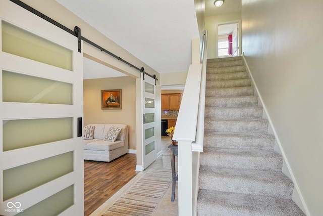 101 Meadowview Dr, Mooresville, IN 46158 - stairway with a barn door, baseboards, and wood finished floors