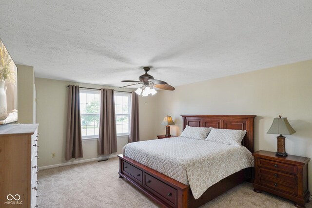 101 Meadowview Dr, Mooresville, IN 46158 - bedroom with light carpet, a textured ceiling, a ceiling fan, and baseboards