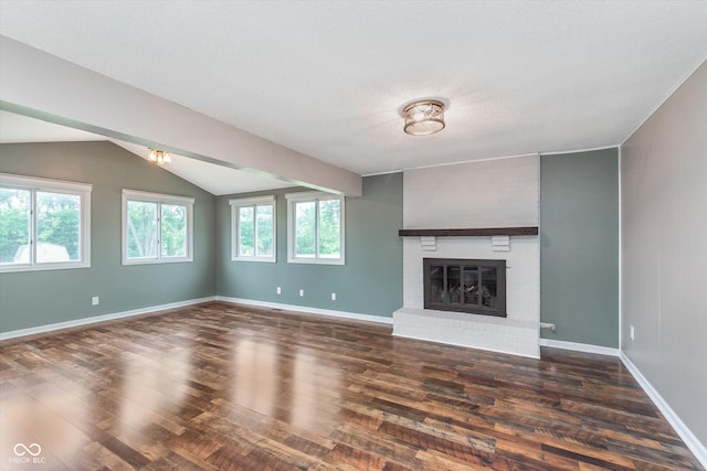 8205 Picadilly Ln, Indianapolis, IN 46256 - unfurnished living room featuring dark wood-type flooring, lofted ceiling, a fireplace, and baseboards