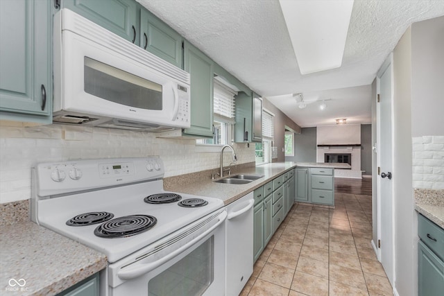 8205 Picadilly Ln, Indianapolis, IN 46256 - kitchen featuring white appliances, a sink, light countertops, tasteful backsplash, and a peninsula