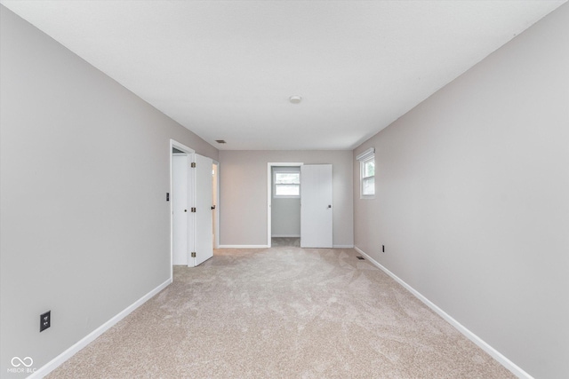 8205 Picadilly Ln, Indianapolis, IN 46256 - unfurnished bedroom featuring baseboards and light carpet
