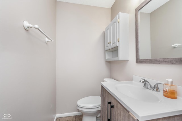 8205 Picadilly Ln, Indianapolis, IN 46256 - half bathroom featuring toilet, vanity, tile patterned flooring, and baseboards
