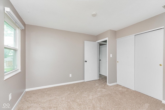 8205 Picadilly Ln, Indianapolis, IN 46256 - unfurnished bedroom featuring carpet floors, a closet, and baseboards