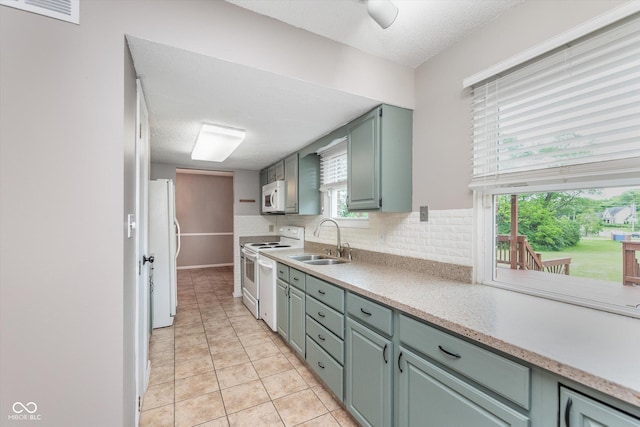 8205 Picadilly Ln, Indianapolis, IN 46256 - kitchen with white appliances, a sink, light countertops, decorative backsplash, and light tile patterned floors