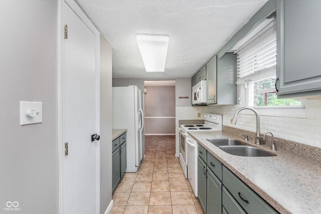 8205 Picadilly Ln, Indianapolis, IN 46256 - kitchen featuring white appliances, a sink, backsplash, gray cabinetry, and a textured ceiling