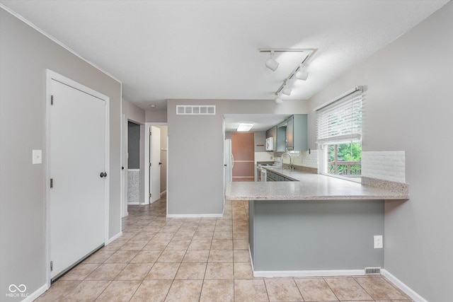8205 Picadilly Ln, Indianapolis, IN 46256 - kitchen featuring light countertops, light tile patterned floors, a sink, and decorative backsplash