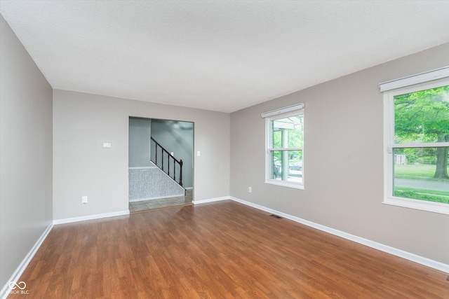 8205 Picadilly Ln, Indianapolis, IN 46256 - spare room featuring stairway, wood finished floors, and baseboards