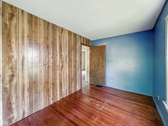 621 N Livingston Ave, Indianapolis, IN 46222 - empty room featuring wood finished floors and wooden walls