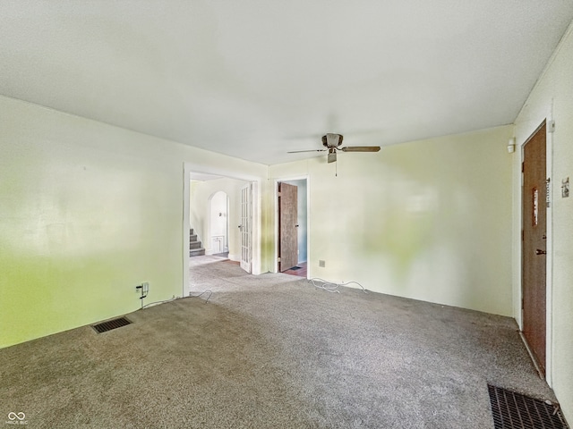 621 N Livingston Ave, Indianapolis, IN 46222 - empty room with arched walkways, carpet, and a ceiling fan