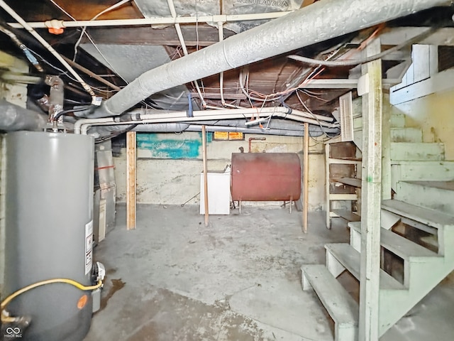 621 N Livingston Ave, Indianapolis, IN 46222 - unfinished basement featuring water heater, oil tank, stairway, and washer / clothes dryer