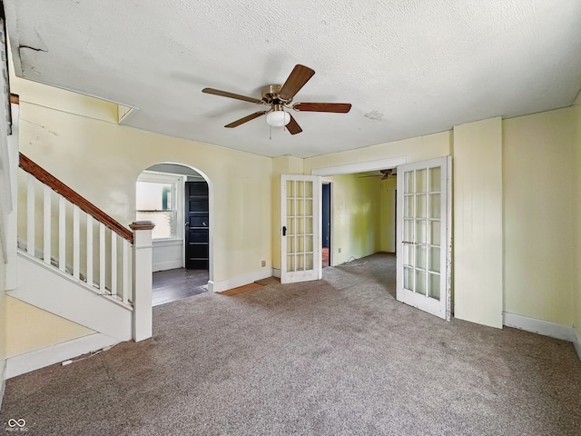 621 N Livingston Ave, Indianapolis, IN 46222 - unfurnished room with french doors, ceiling fan, arched walkways, carpet floors, and a textured ceiling