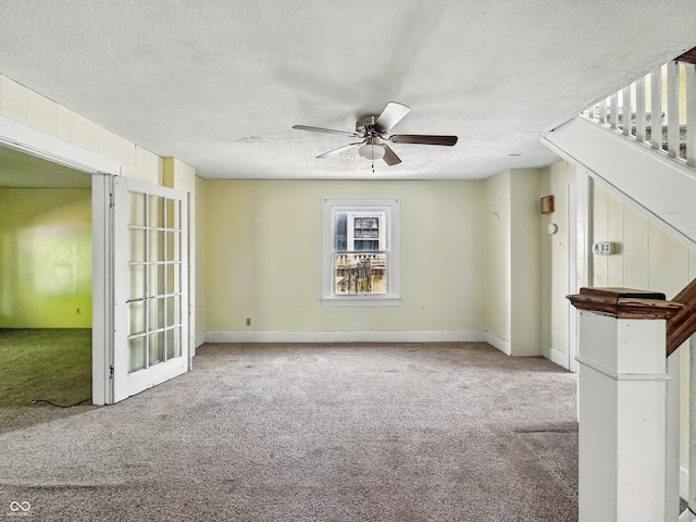 621 N Livingston Ave, Indianapolis, IN 46222 - unfurnished living room featuring carpet, a ceiling fan, a textured ceiling, stairs, and baseboards