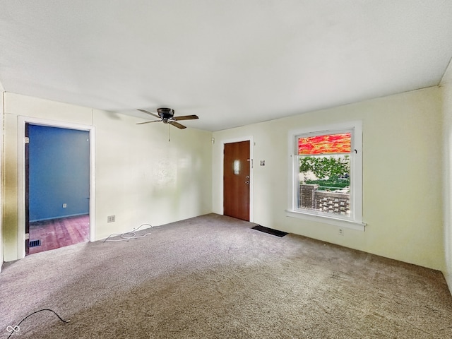 621 N Livingston Ave, Indianapolis, IN 46222 - unfurnished living room with carpet flooring and ceiling fan