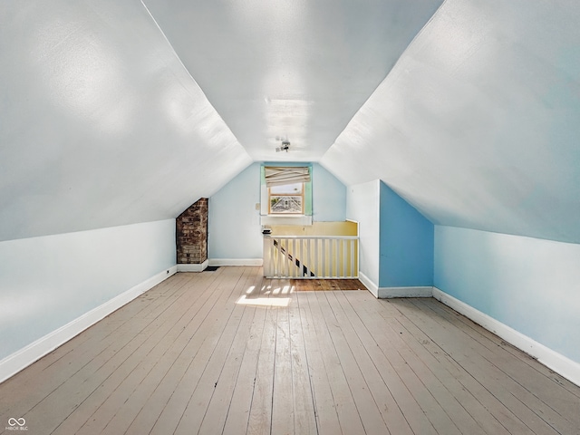 621 N Livingston Ave, Indianapolis, IN 46222 - additional living space with baseboards, lofted ceiling, and hardwood / wood-style flooring