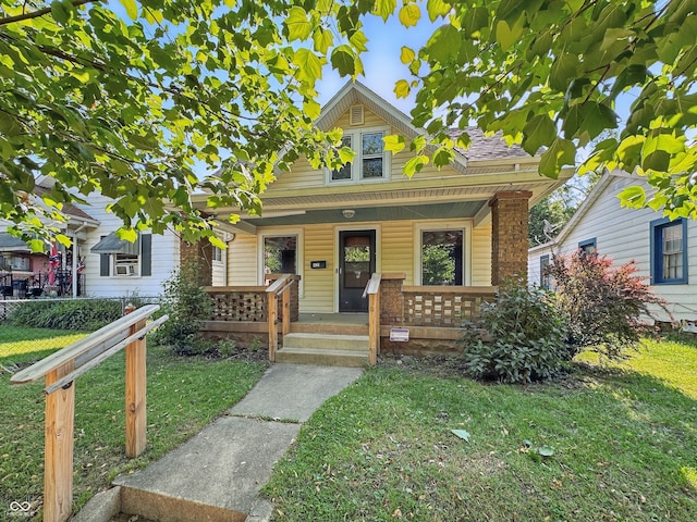 621 N Livingston Ave, Indianapolis, IN 46222 - bungalow-style house with a porch and brick siding