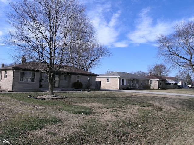 3456 S Sadlier Dr S, Indianapolis, IN 46239 - ranch-style house with a front yard and a chimney