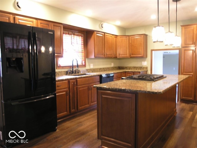 3456 S Sadlier Dr S, Indianapolis, IN 46239 - kitchen featuring black appliances, a sink, a kitchen island, light stone countertops, and dark wood finished floors