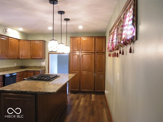 3456 S Sadlier Dr S, Indianapolis, IN 46239 - kitchen with black dishwasher, dark wood-style floors, gas stovetop, a kitchen island, and brown cabinetry