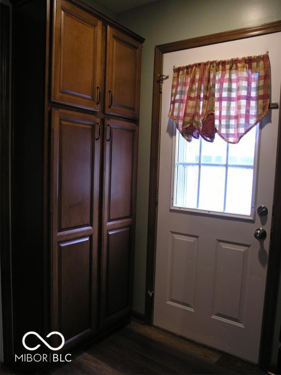 3456 S Sadlier Dr S, Indianapolis, IN 46239 - doorway to outside with dark wood finished floors