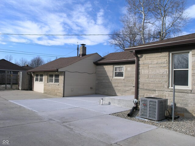 3456 S Sadlier Dr S, Indianapolis, IN 46239 - rear view of property with central AC unit and roof with shingles