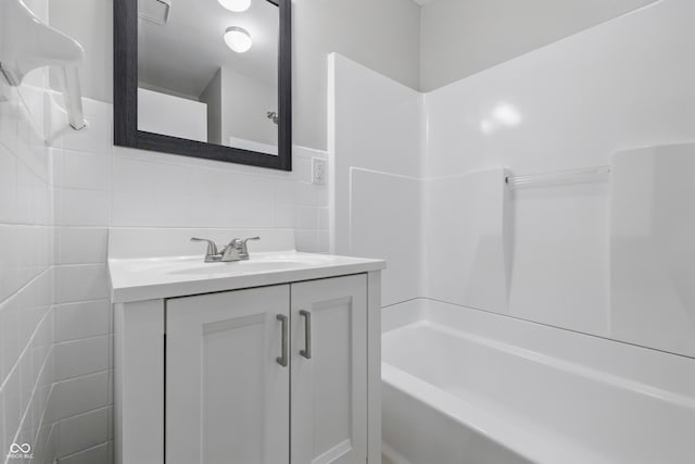 450 N Fenton Ave, Indianapolis, IN 46219 - full bath with tile walls, vanity, and bathing tub / shower combination