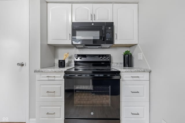 450 N Fenton Ave, Indianapolis, IN 46219 - kitchen with black appliances, white cabinets, and light stone countertops