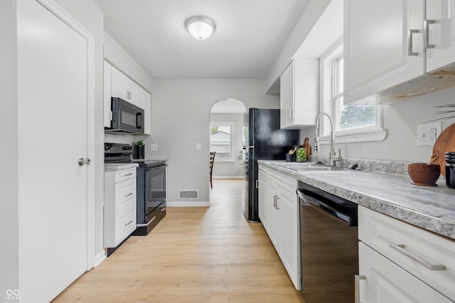 450 N Fenton Ave, Indianapolis, IN 46219 - kitchen featuring black appliances, light wood finished floors, white cabinetry, and light countertops