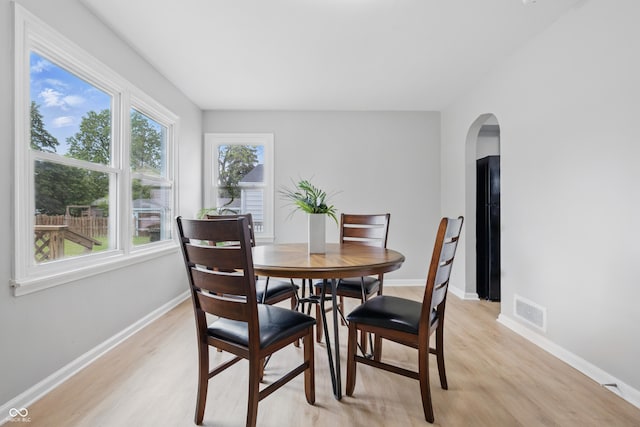 450 N Fenton Ave, Indianapolis, IN 46219 - dining space with light wood-style floors, healthy amount of natural light, and arched walkways