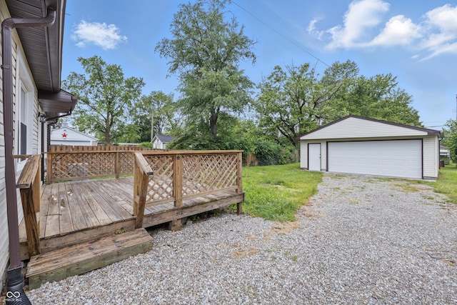 450 N Fenton Ave, Indianapolis, IN 46219 - view of yard featuring a detached garage, an outdoor structure, and a wooden deck