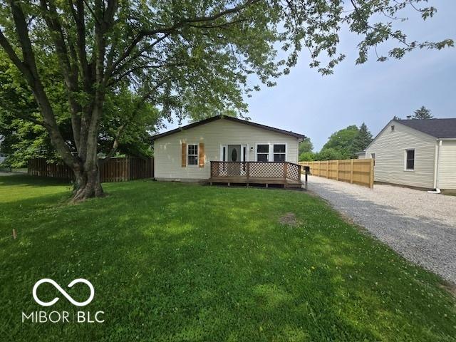 450 N Fenton Ave, Indianapolis, IN 46219 - view of front of house featuring driveway and a wooden deck