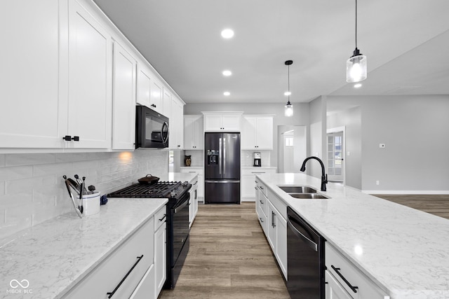 4545 Caroline Grace Ln, Terre Haute, IN 47802 - kitchen with black appliances, recessed lighting, white cabinetry, tasteful backsplash, and decorative light fixtures