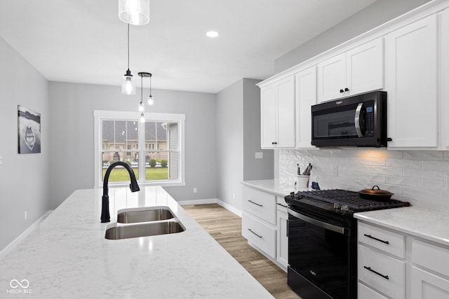 4545 Caroline Grace Ln, Terre Haute, IN 47802 - kitchen featuring black appliances, tasteful backsplash, light stone counters, white cabinetry, and light wood finished floors