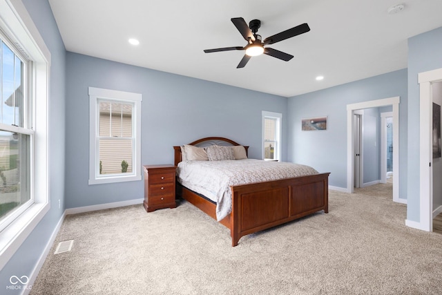 4545 Caroline Grace Ln, Terre Haute, IN 47802 - bedroom with light colored carpet, multiple windows, ceiling fan, and recessed lighting