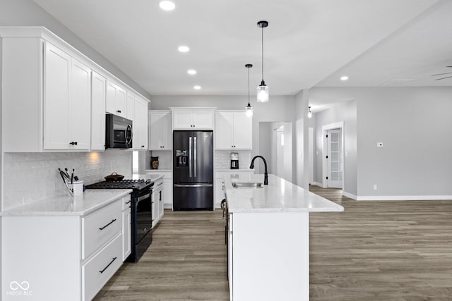 4545 Caroline Grace Ln, Terre Haute, IN 47802 - kitchen featuring appliances with stainless steel finishes, recessed lighting, white cabinets, tasteful backsplash, and hanging light fixtures