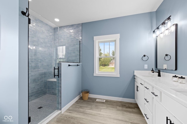 4545 Caroline Grace Ln, Terre Haute, IN 47802 - full bathroom featuring double vanity, a shower stall, wood finished floors, and recessed lighting