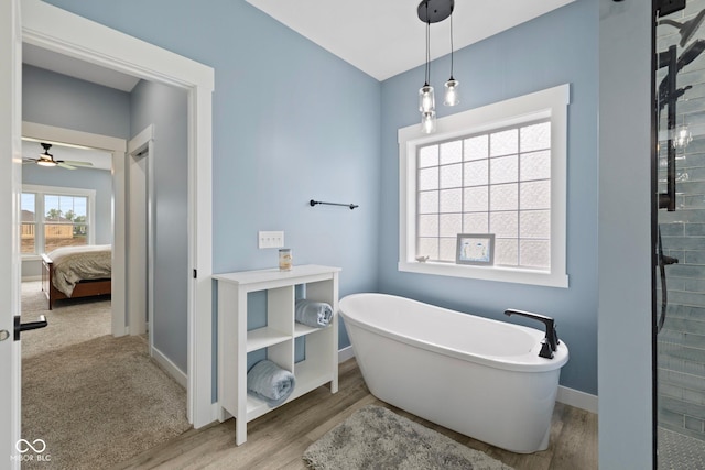 4545 Caroline Grace Ln, Terre Haute, IN 47802 - ensuite bathroom featuring wood finished floors, a soaking tub, a ceiling fan, and tiled shower