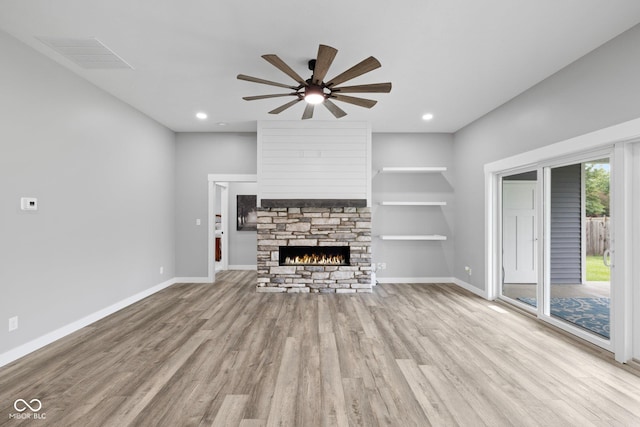4545 Caroline Grace Ln, Terre Haute, IN 47802 - unfurnished living room with light wood finished floors, ceiling fan, a stone fireplace, and recessed lighting