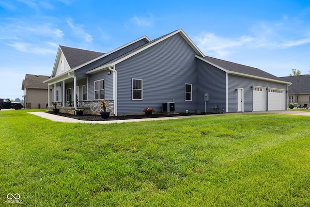 4545 Caroline Grace Ln, Terre Haute, IN 47802 - view of side of home with a garage, a yard, concrete driveway, a shingled roof, and a porch