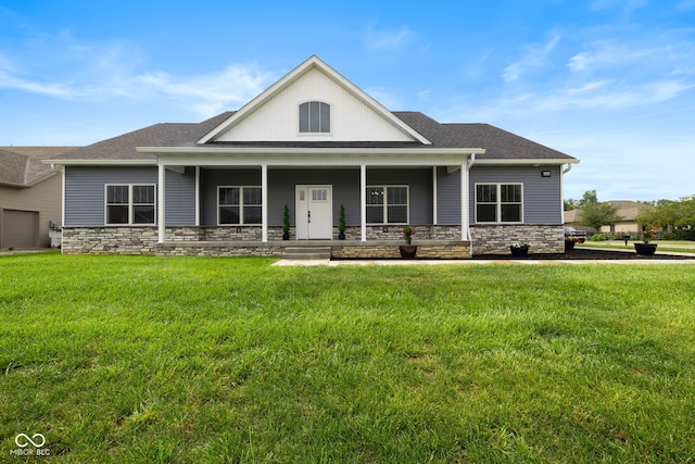 4545 Caroline Grace Ln, Terre Haute, IN 47802 - view of front of property with stone siding, a front lawn, roof with shingles, and a porch