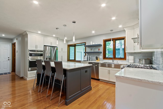 7426 Shadow Wood Dr, Indianapolis, IN 46254 - kitchen with appliances with stainless steel finishes, a sink, backsplash, light stone countertops, and recessed lighting