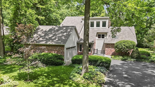 7426 Shadow Wood Dr, Indianapolis, IN 46254 - view of front of property featuring an attached garage, brick siding, roof with shingles, and a front yard