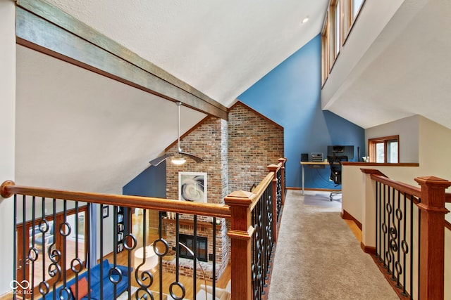 7426 Shadow Wood Dr, Indianapolis, IN 46254 - corridor with baseboards, an upstairs landing, carpet flooring, vaulted ceiling, and brick wall