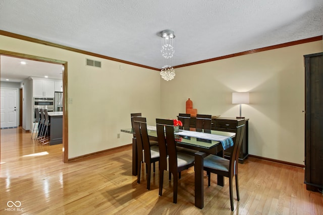 7426 Shadow Wood Dr, Indianapolis, IN 46254 - dining space with light wood-type flooring, baseboards, ornamental molding, a chandelier, and a textured ceiling