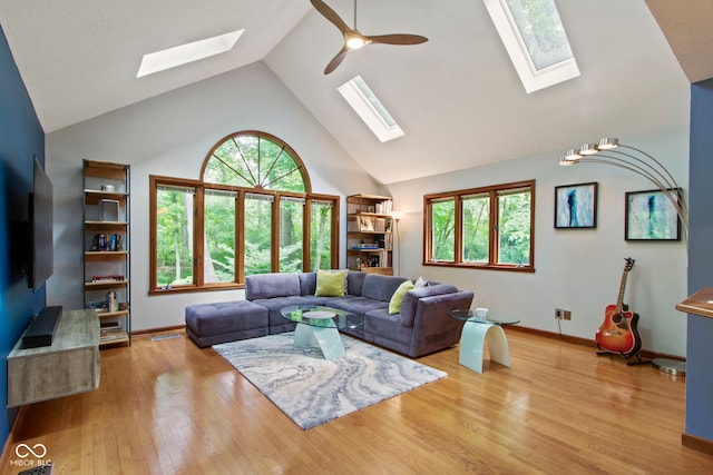 7426 Shadow Wood Dr, Indianapolis, IN 46254 - living area with a skylight, high vaulted ceiling, a ceiling fan, and baseboards