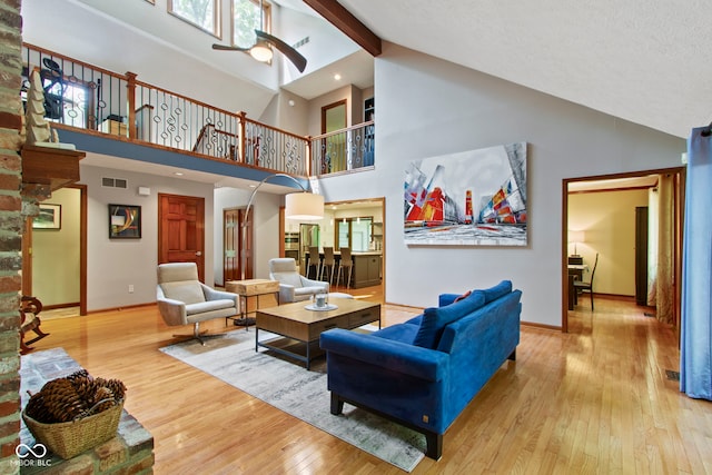 7426 Shadow Wood Dr, Indianapolis, IN 46254 - living room with high vaulted ceiling, ceiling fan, baseboards, hardwood / wood-style flooring, and beam ceiling