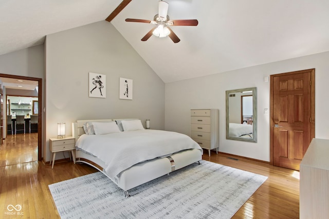 7426 Shadow Wood Dr, Indianapolis, IN 46254 - bedroom featuring light wood-style floors, a ceiling fan, high vaulted ceiling, baseboards, and beamed ceiling