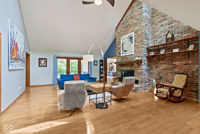 7426 Shadow Wood Dr, Indianapolis, IN 46254 - living room with light wood-style floors, a fireplace, high vaulted ceiling, ceiling fan, and baseboards