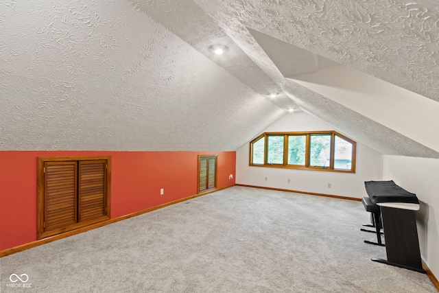 7426 Shadow Wood Dr, Indianapolis, IN 46254 - bonus room featuring a textured ceiling, baseboards, vaulted ceiling, and carpet floors