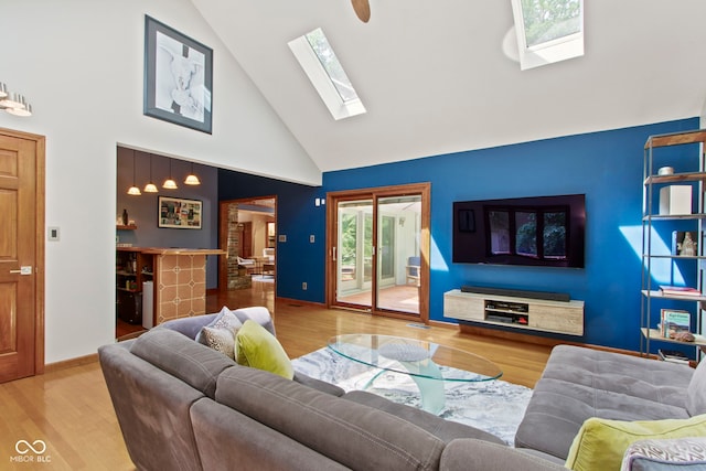7426 Shadow Wood Dr, Indianapolis, IN 46254 - living area featuring high vaulted ceiling, a skylight, wood finished floors, and baseboards